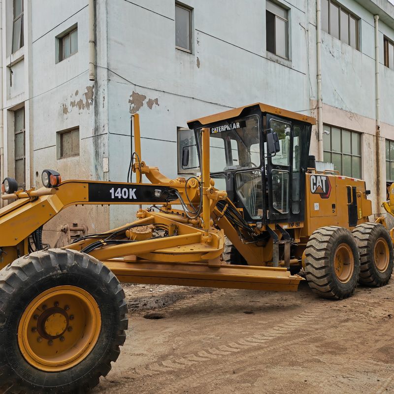 ব্যবহৃত খননকারী জমির সমতলকরণকারী Caterpillar CAT140K রোডার মেশিন ভাল অবস্থায় ব্যবহৃত জাপান ট্র্যাক্টর ইঞ্জিন