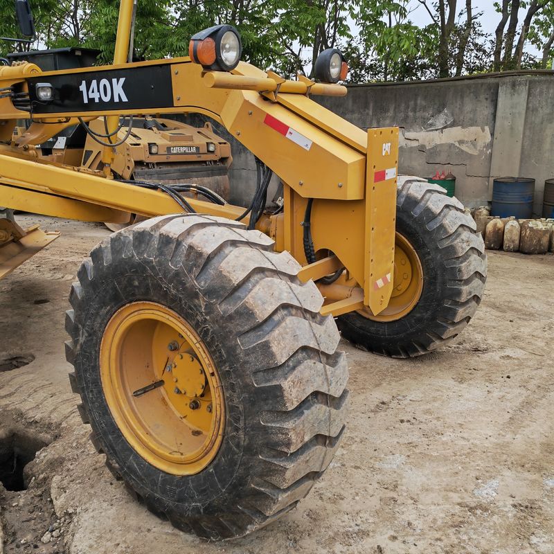 ব্যবহৃত খননকারী জমির সমতলকরণকারী Caterpillar CAT140K রোডার মেশিন ভাল অবস্থায় ব্যবহৃত জাপান ট্র্যাক্টর ইঞ্জিন